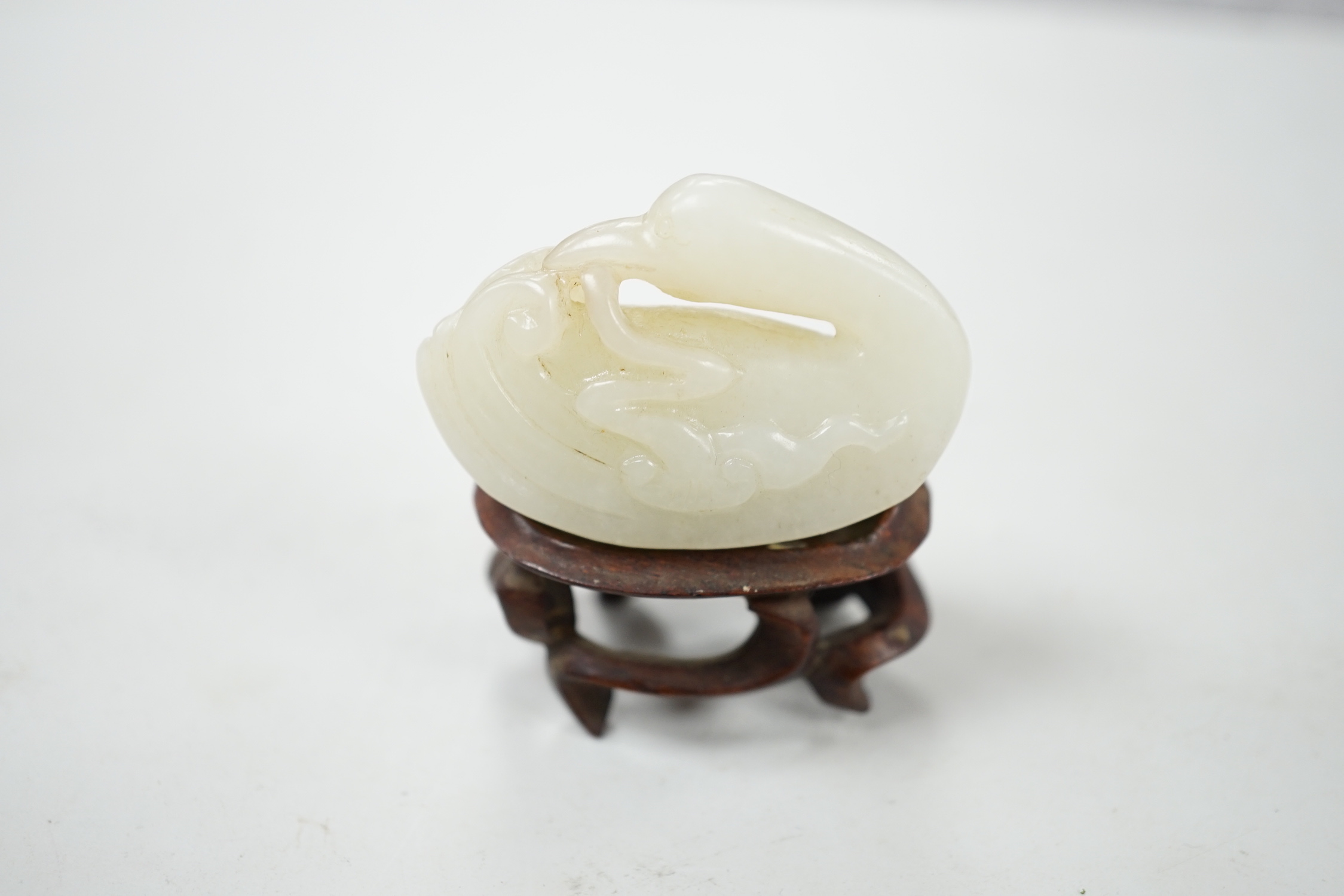 Two Chinese jades, and a wooden stand, largest jade 17.5 cm long